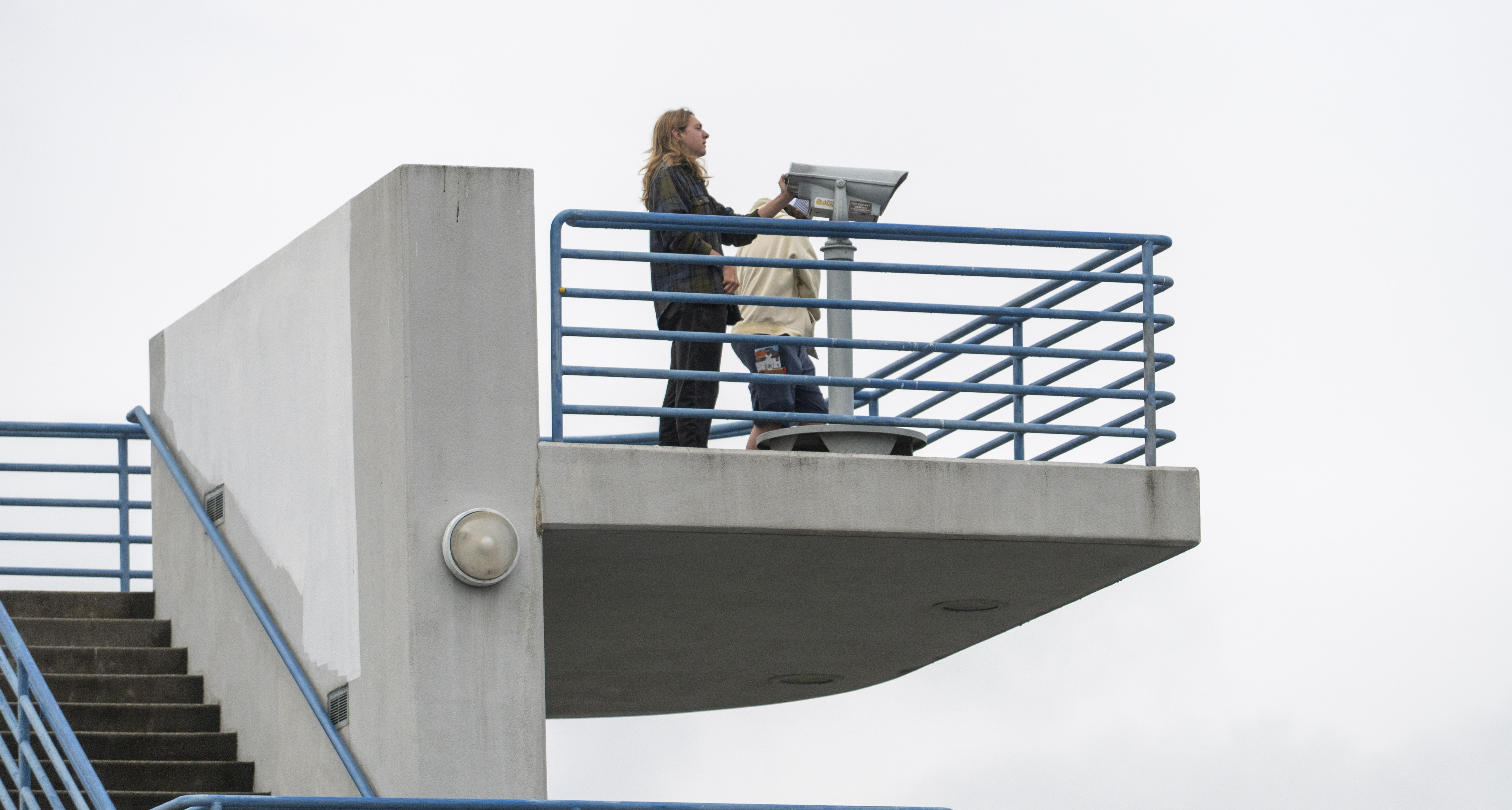Two people stand on an observation deck.