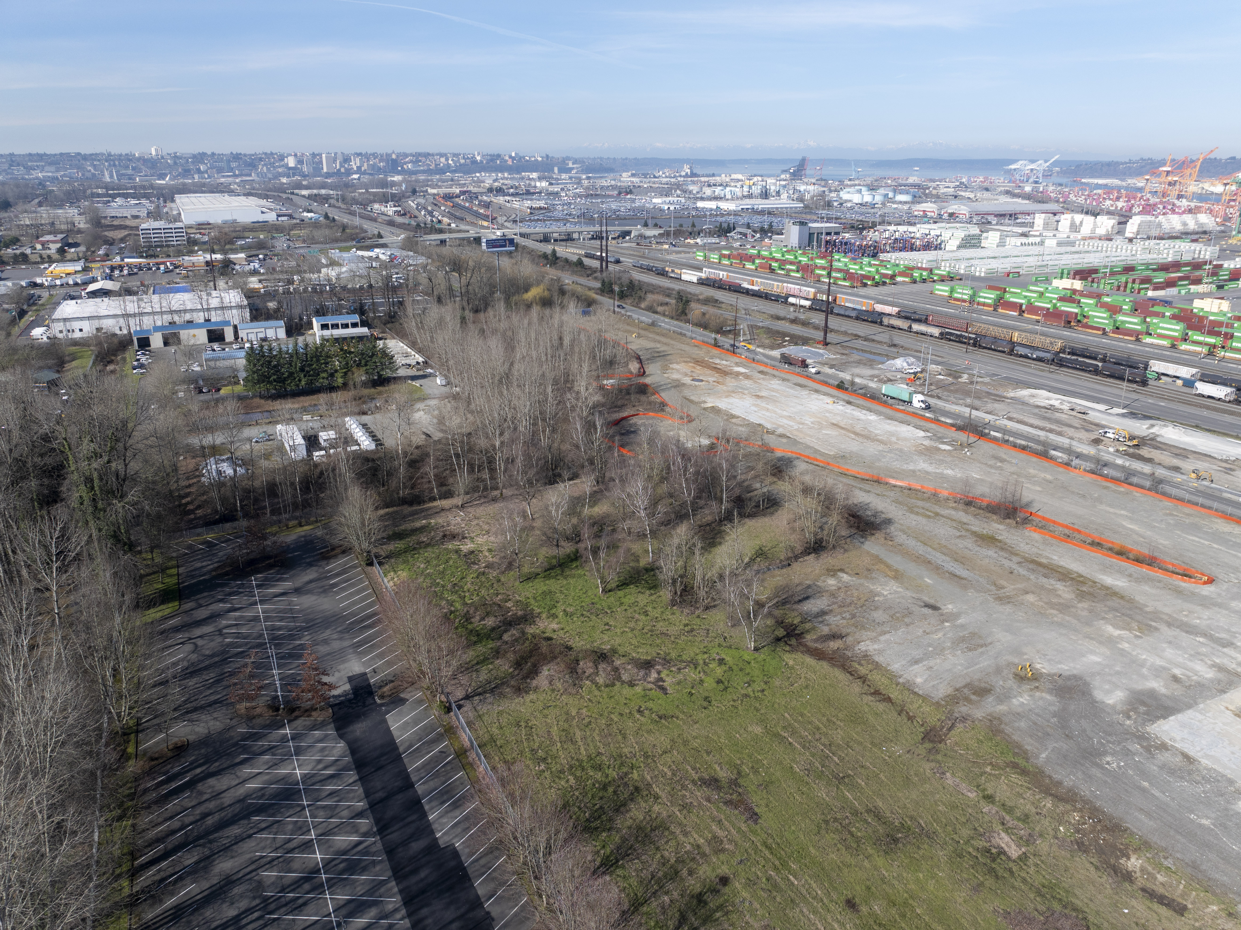 Aerial photo of vacant land and a parking lot near a Port terminal on a sunny day.
