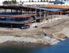 Aerial shot of a building under construction along the shoreline.