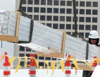 Video still of a construction worker installing solar panels. 