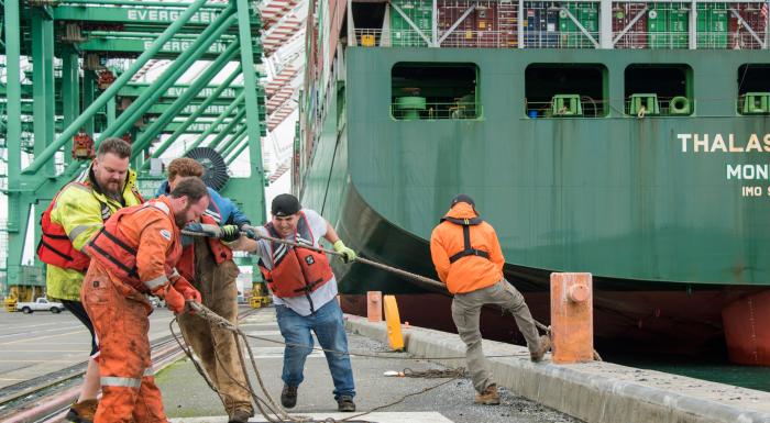 photo of group of men handling a ship line
