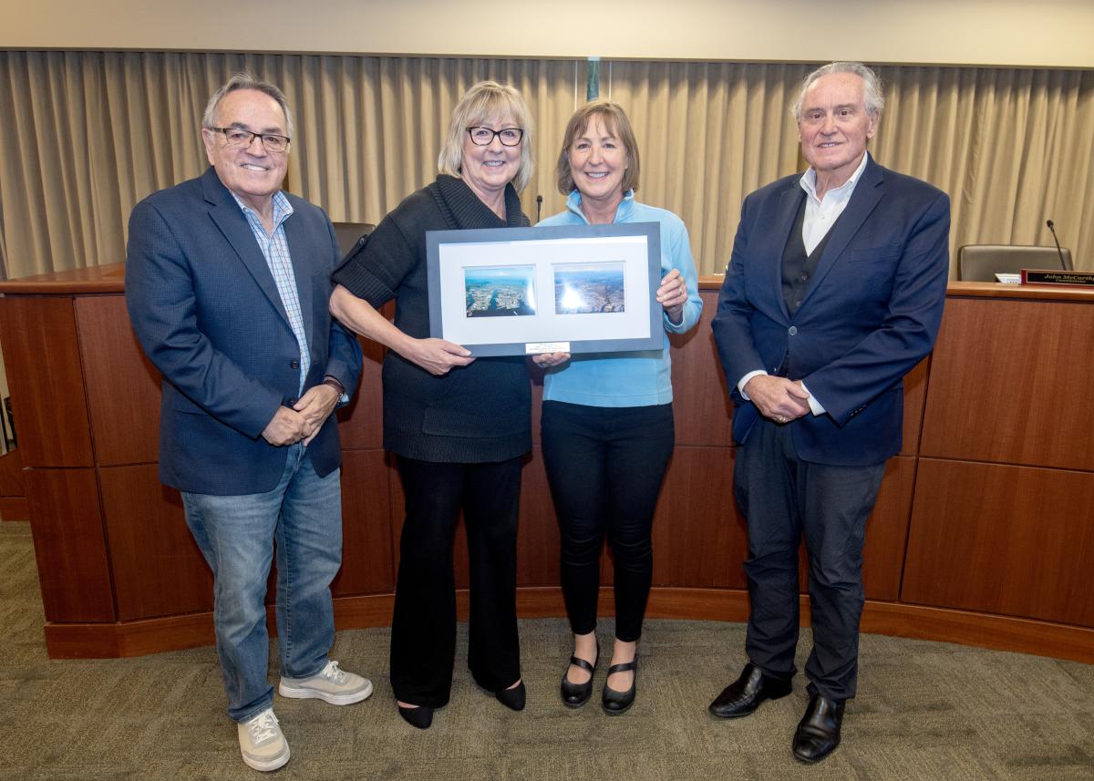 Brenda Hauge stands with Port Commissioners Marzano, Keller, and McCarthy