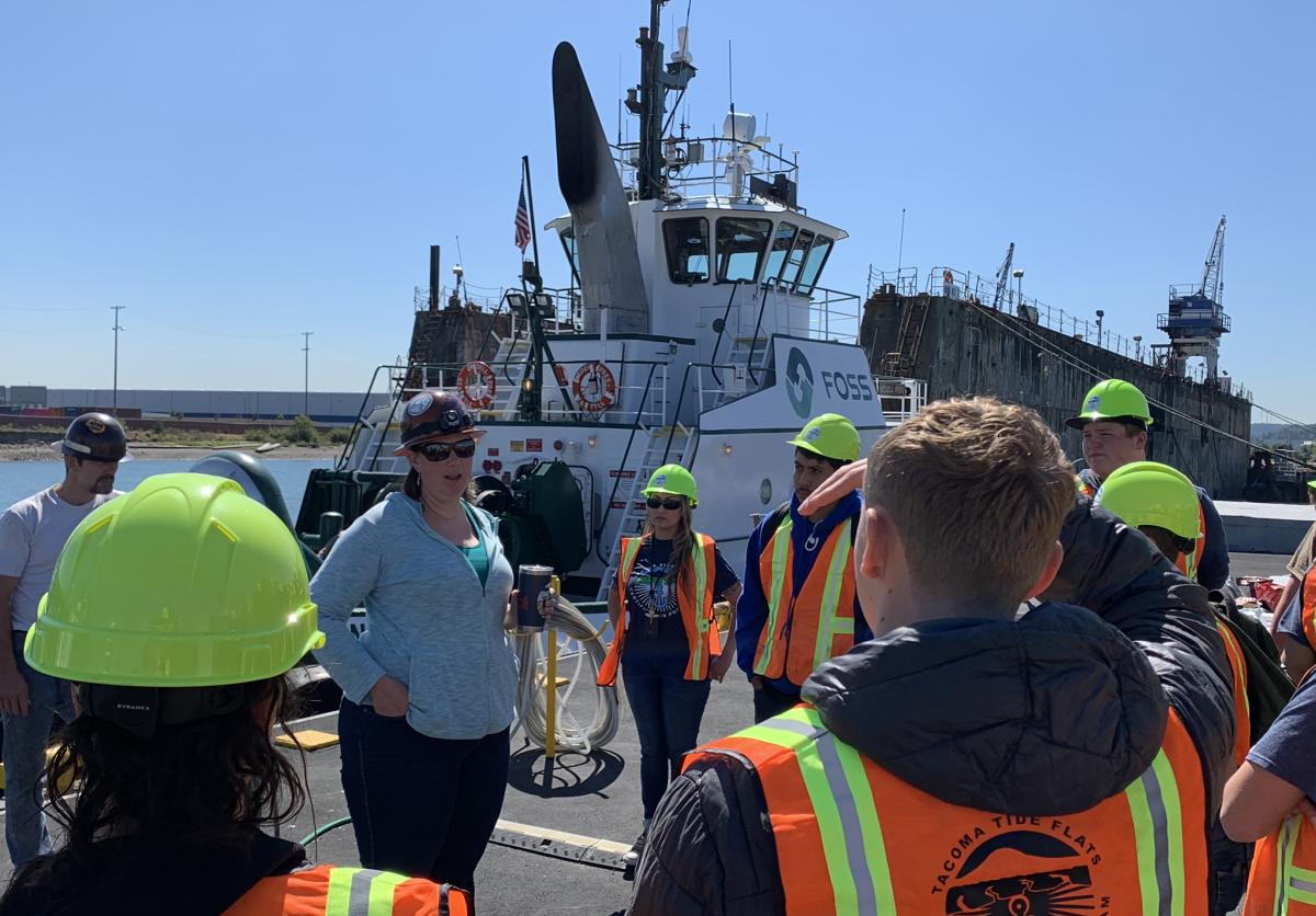 Teacher instructs students on the waterfront.